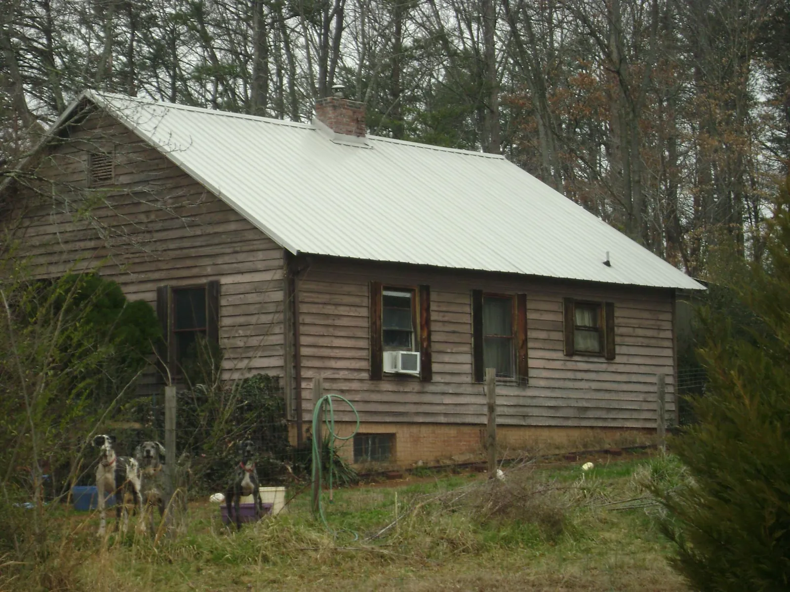 White metal roof on an old wood sided farmhouse, from a Metal Roof Installation job in Eltopia
